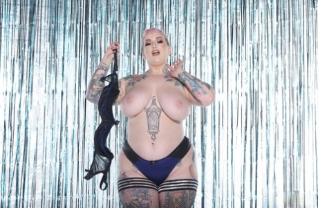 The hairy BBW Cherrie Pie of pink hues strips and displays her inked booty with monster-like features.