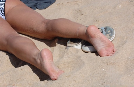 Ivana, the amateur sex worker from Little Italy, flaunting her small figure while lounging on the beach.