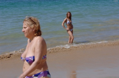 At the beach, Ivana, a young adult, flaunting her buttocks and small hands.