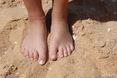 Intimate presence: American female model Ivana poses on the sand, clutching her tiny fidgety moutchetties.