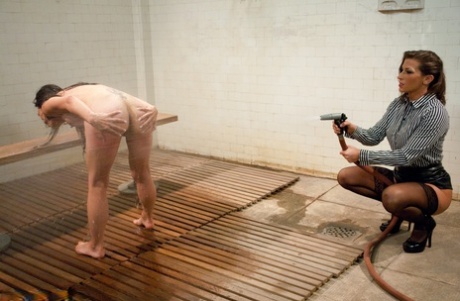 An enema is administered to Asian inmate Tia Ling before being hosed down by warden Ariel X.