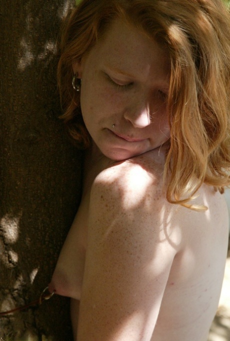 Redheaded Babe Tied To A Tree Gets Spanked By A Stranger In The Park