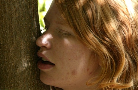 Redheaded Babe Tied To A Tree Gets Spanked By A Stranger In The Park