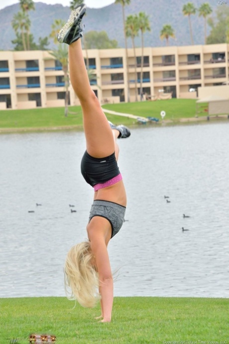 With a modest blonde body, Kaylie takes off her fitness shorts and performs a handstand in the nude.