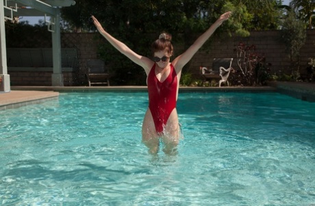 Amateur teen Essie Halladay exposing her big round tits in the swimming pool