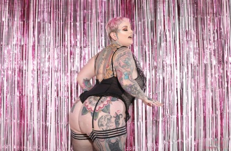 The hot, fatty Galda Lou is displaying her tattooed body in a stunning array of stockings and boots.