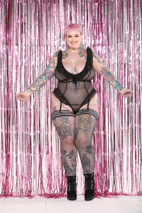 Hot and fatty galda Lou flaunting her tattooed body in stockings and boots.