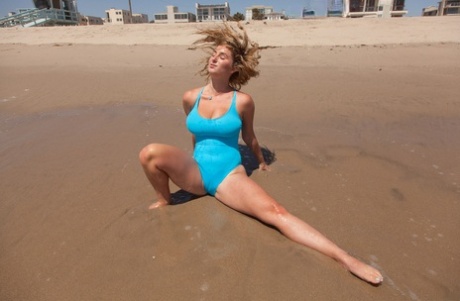 Big boobed teenage girlfriend poses on the beach in sexy blue swimsuit