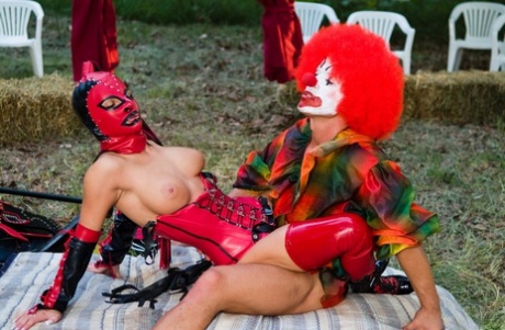 Nikky Rider is seen in a red corset as a masked prostitute, getting double-headed during anal 3some.