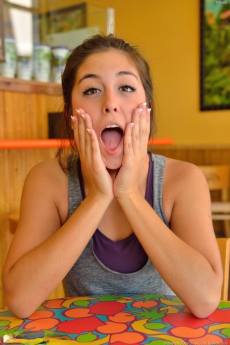 Brunette teen Natalie unveils her cunt and sticks a cucumber in it
