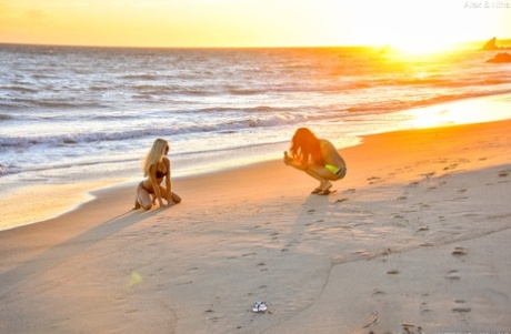 The beach is where Alexia and Nina, slim beauties, flaunt their bodies while wearing bikinis.