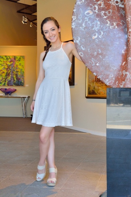 With a cute white dress on her feet, Lily showcases her petite frame in high heels.